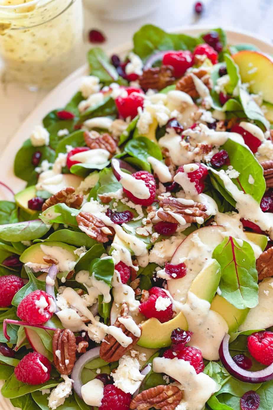 Raspberry, Spinach, and Beet Green Salad - healthy, summer salad recipe loaded with raspberries, pecans, fresh spinach, feta, and beet leaves. This recipe uses just a few ingredients and is simply delicious on its own. But what makes this salad unforgettably delicious is the Creamy Greek Yogurt Herb Dressing. - The Yummy Bowl