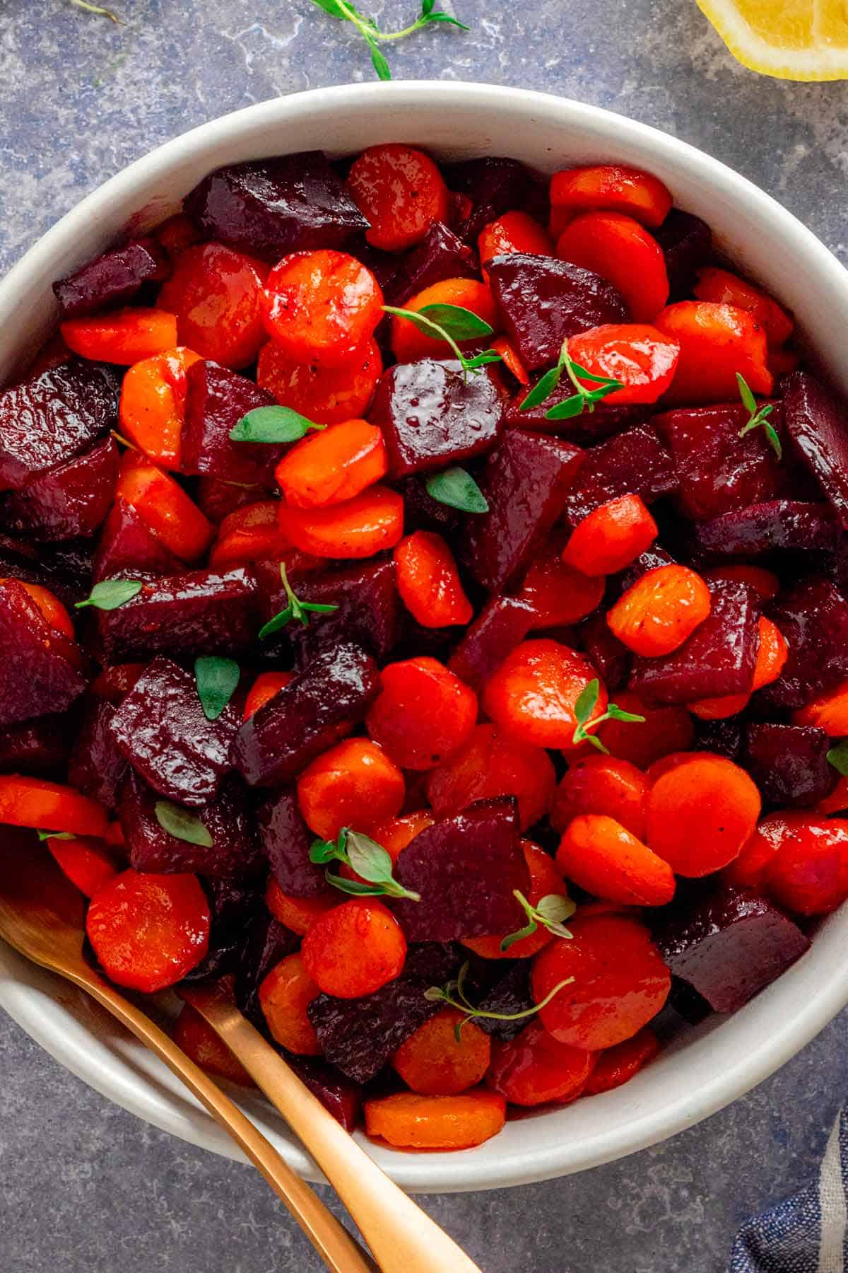 a bowl of roasted beets and carrots in a bowl.