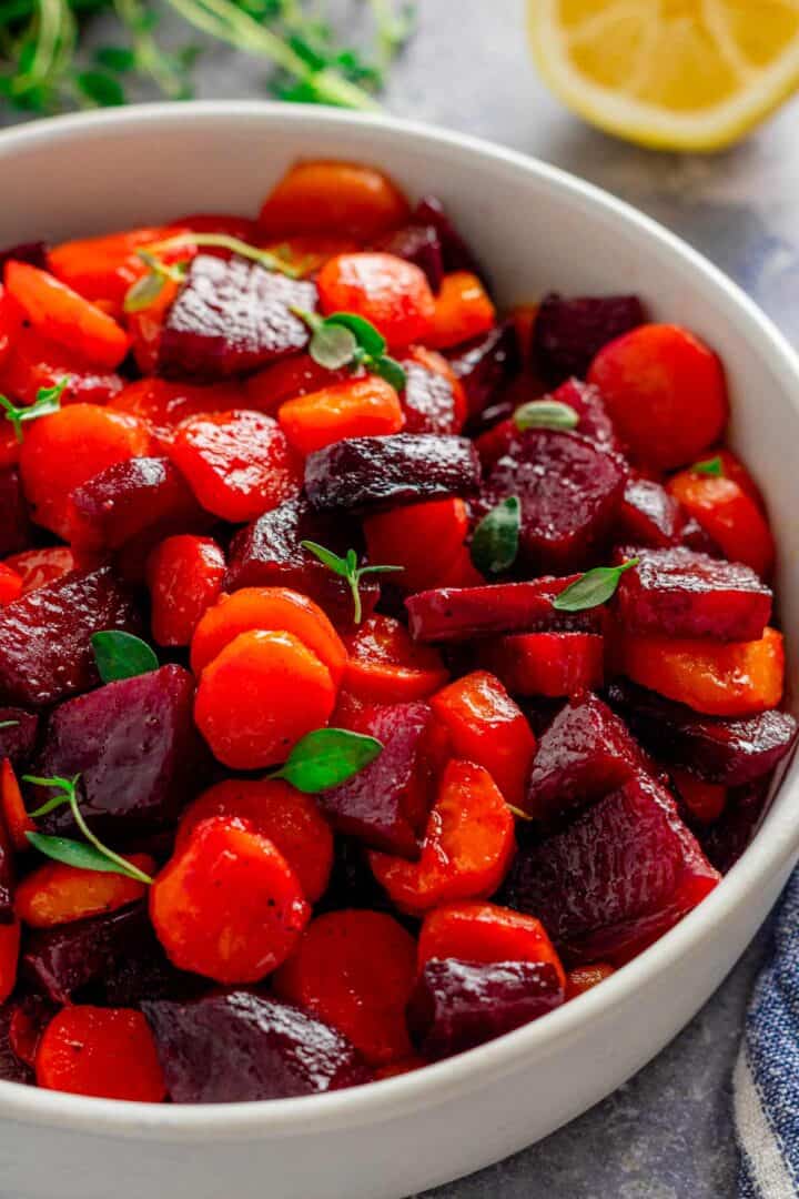 roasted beets and carrots in a bowl with thyme.