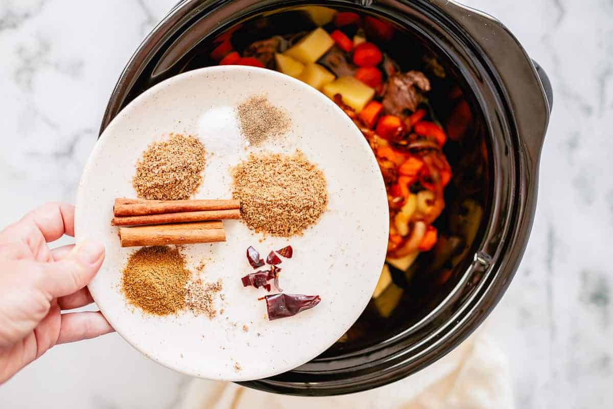 spices on a small plate right before adding to the slow cooker pot on top of the beef and vegetables