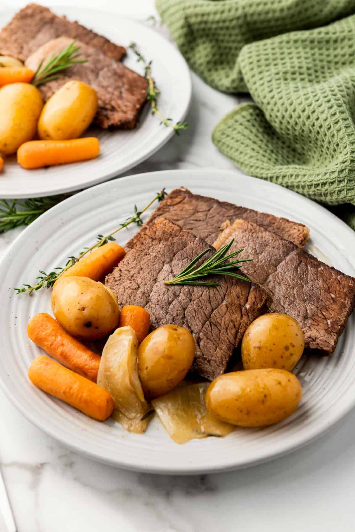 slow cooker rump roast with vegetables on a plate