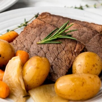 slow cooker rump roast with vegetables on a plate