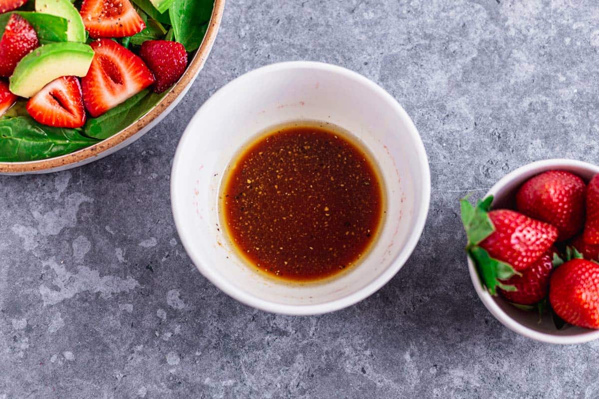 dressing ingredients mixed in a bowl for Spinach Strawberry Salad With Feta