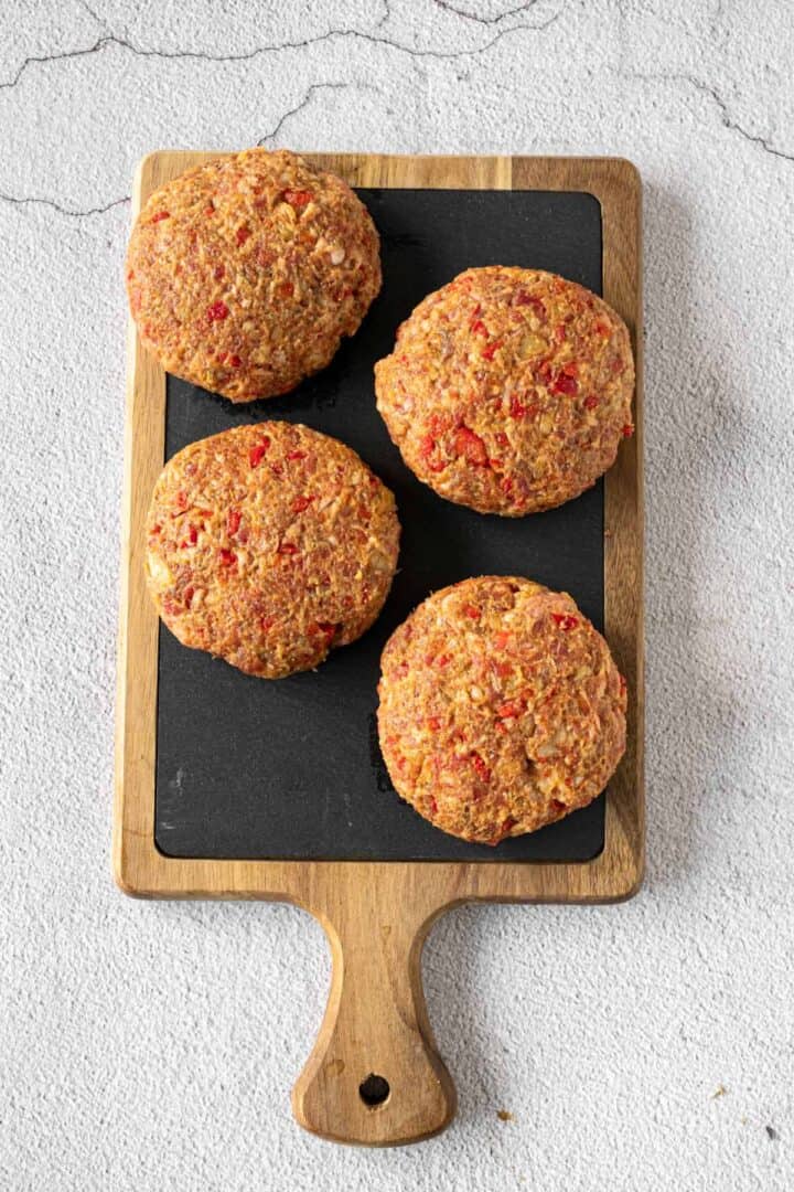 beef patties in wooden board.