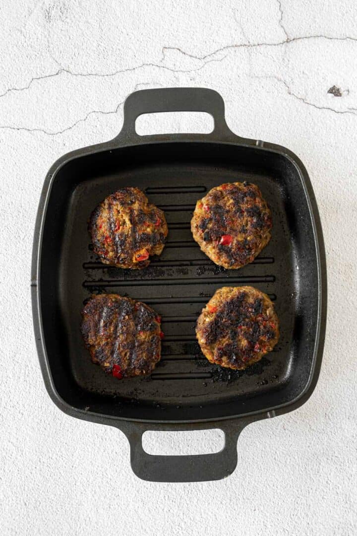 beef patties cooking in grill pan.