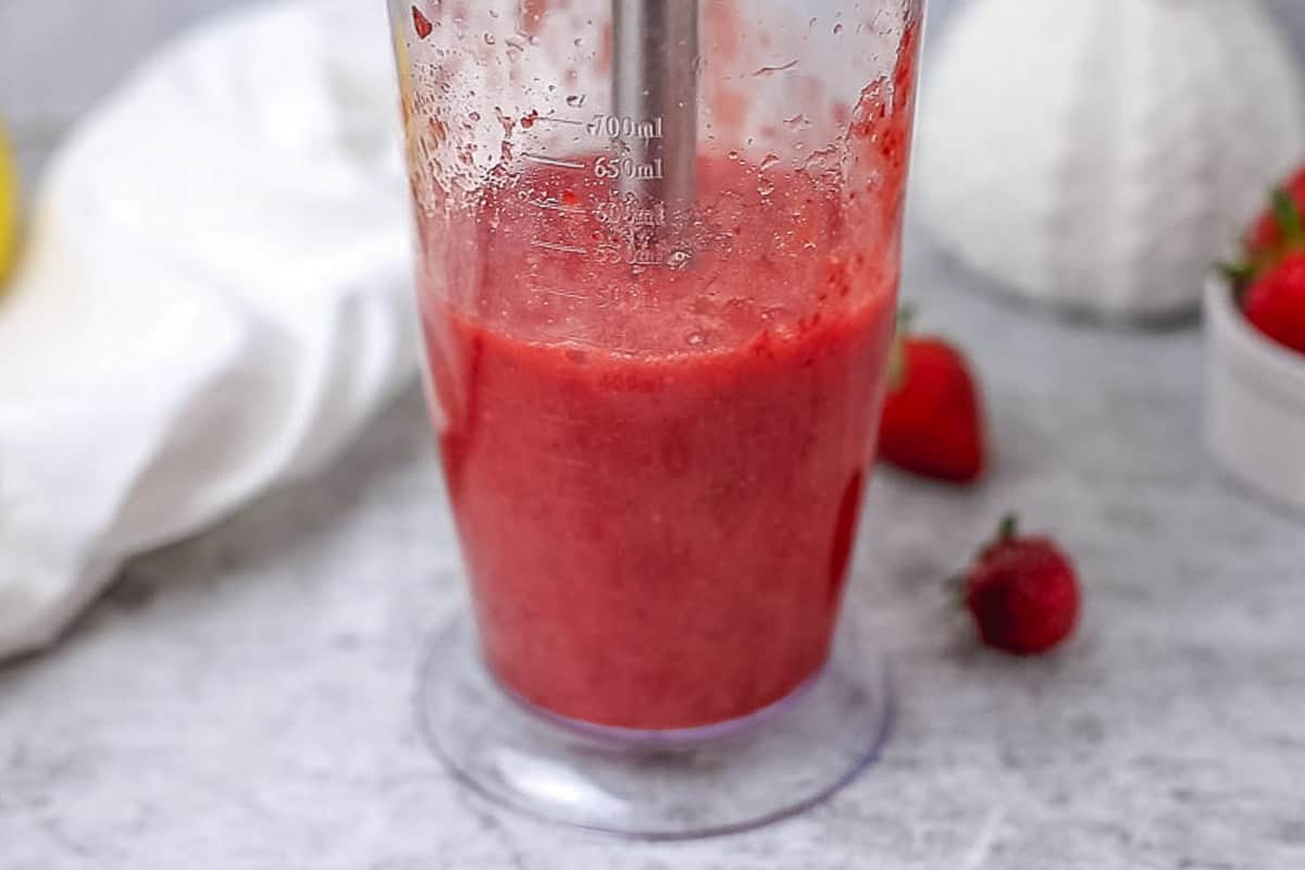 Blended strawberries in a transparent cup