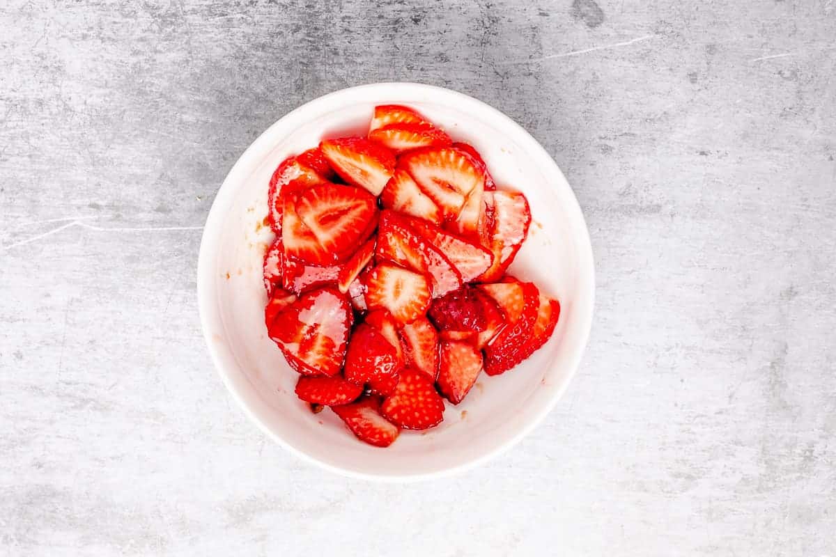 strawberries with brown sugar in a white bowl for french toast