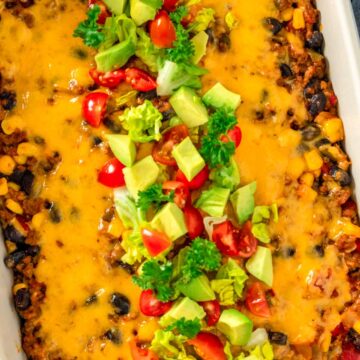 taco casserole with diced tomatoes avocado and cilantro