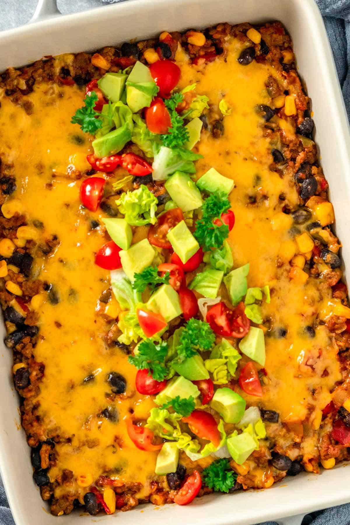 taco casserole with diced tomatoes avocado and cilantro