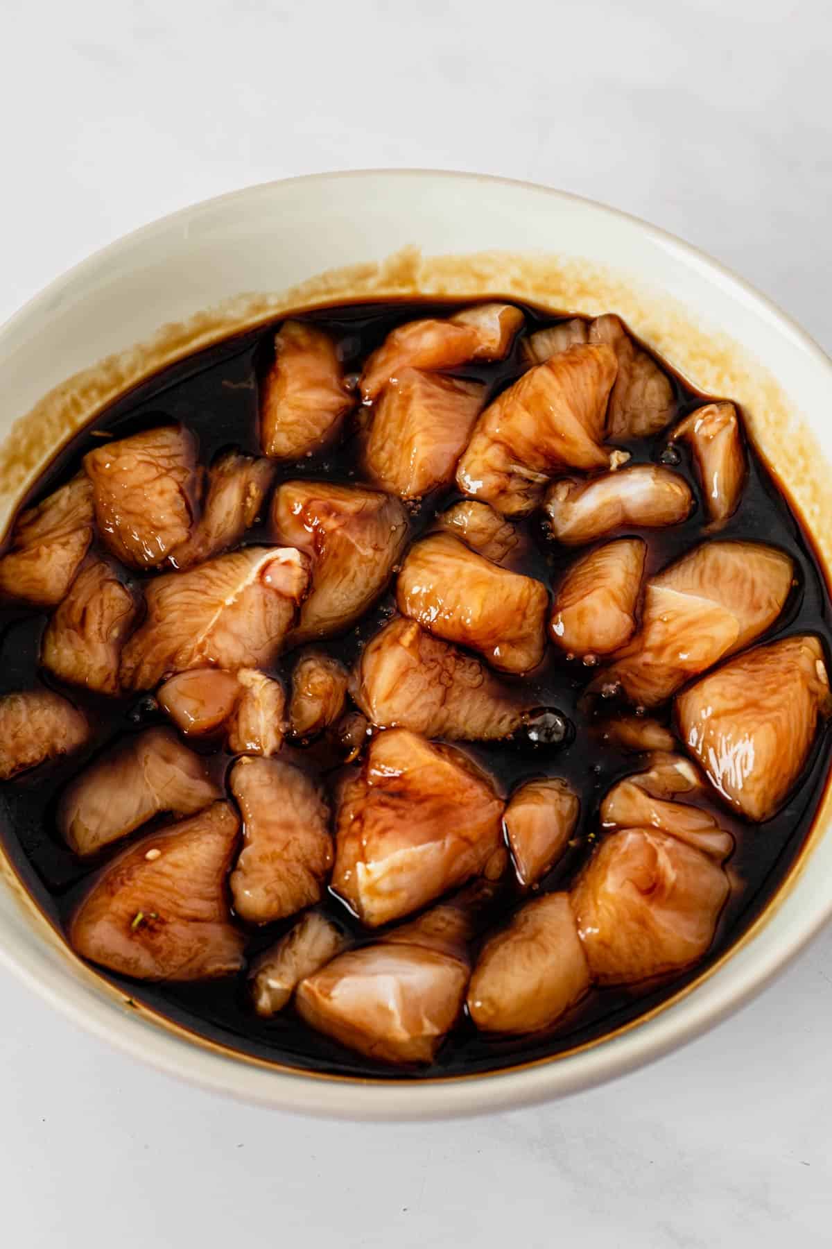 chicken slices marinating in teriyaki sauce