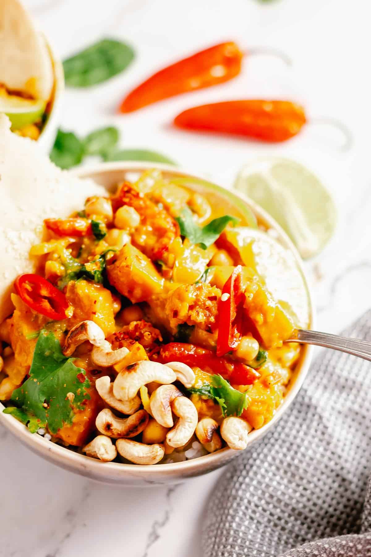 final image of pumpkin curry in a bowl with rice with a marble background