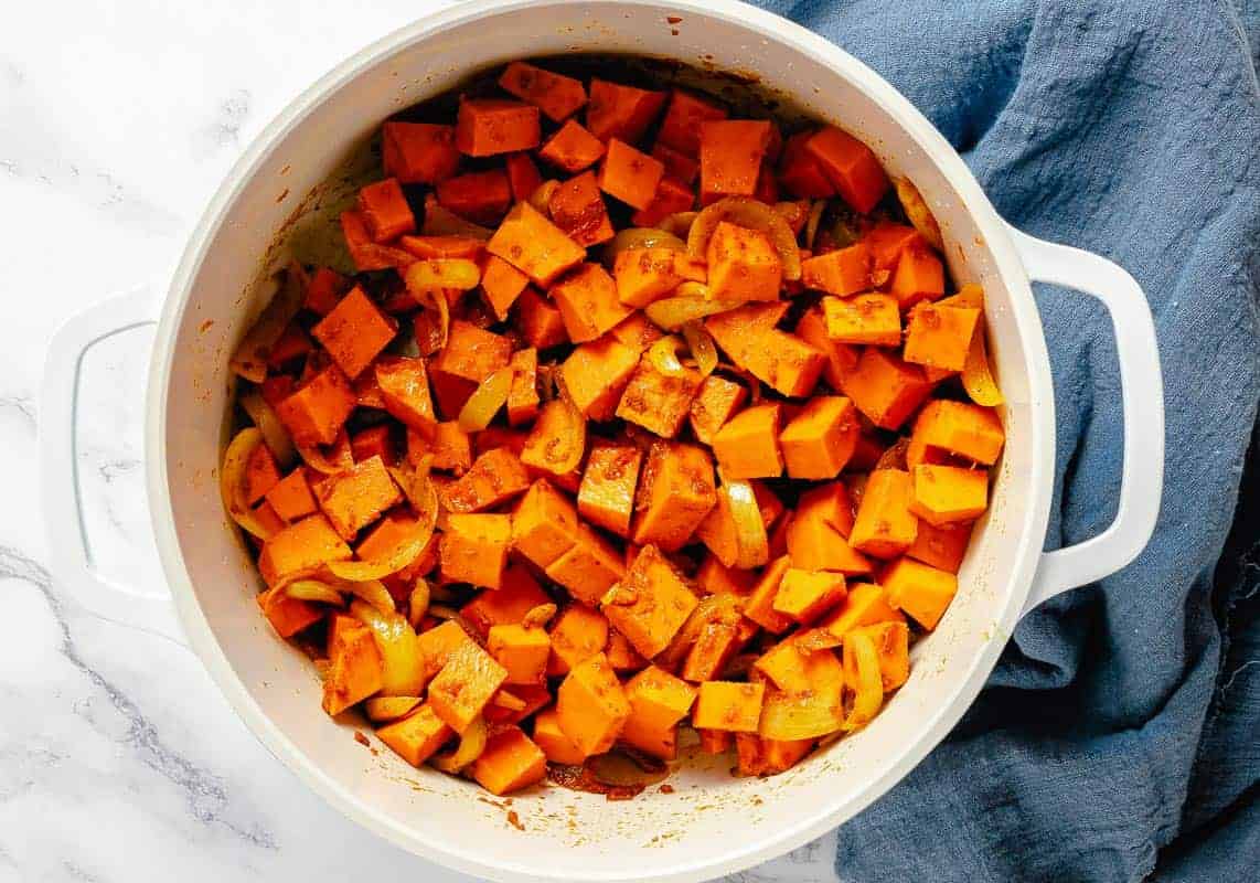 diced pumpkin cubes added to the white pot