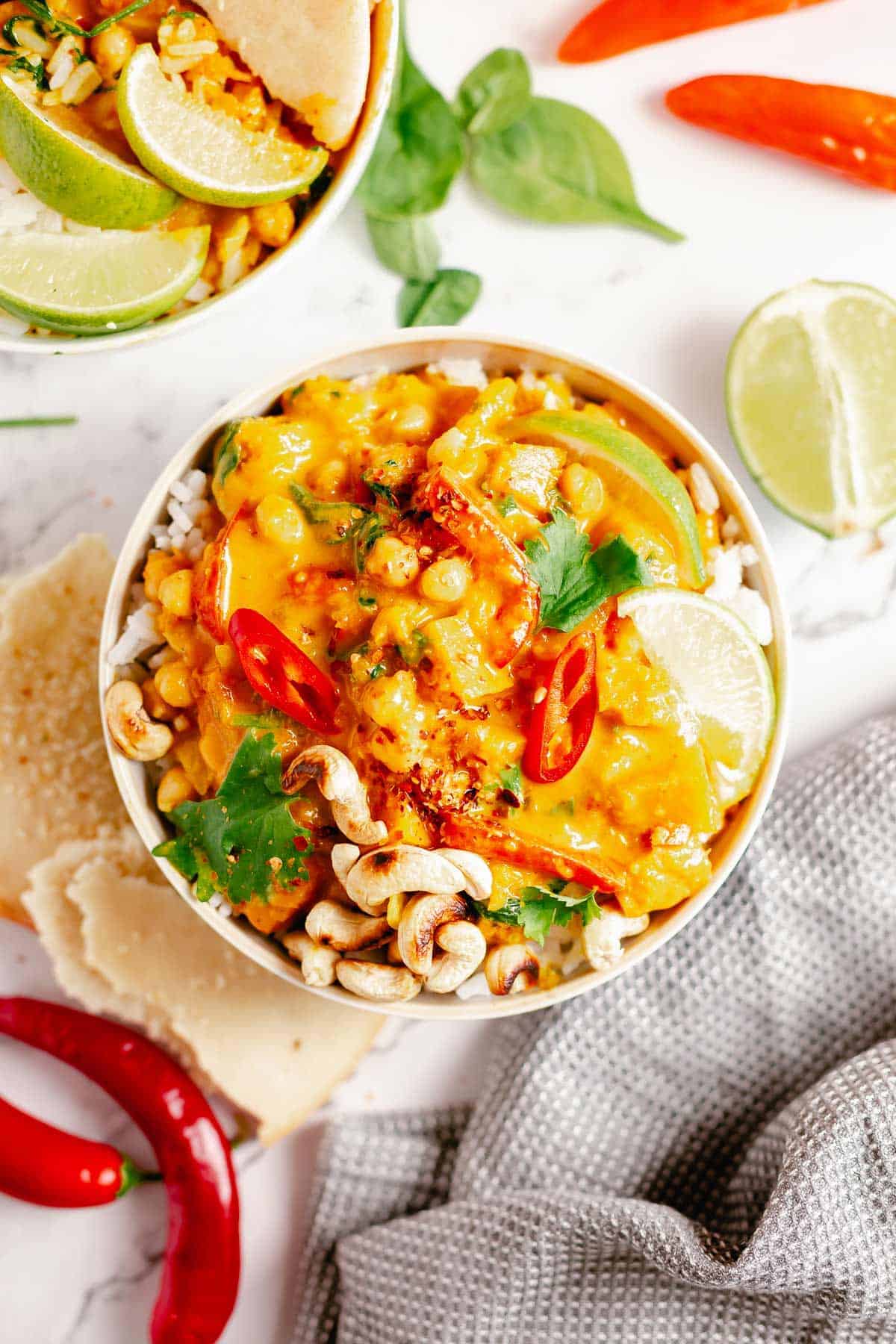 final image of pumpkin curry in a bowl with rice with a marble background