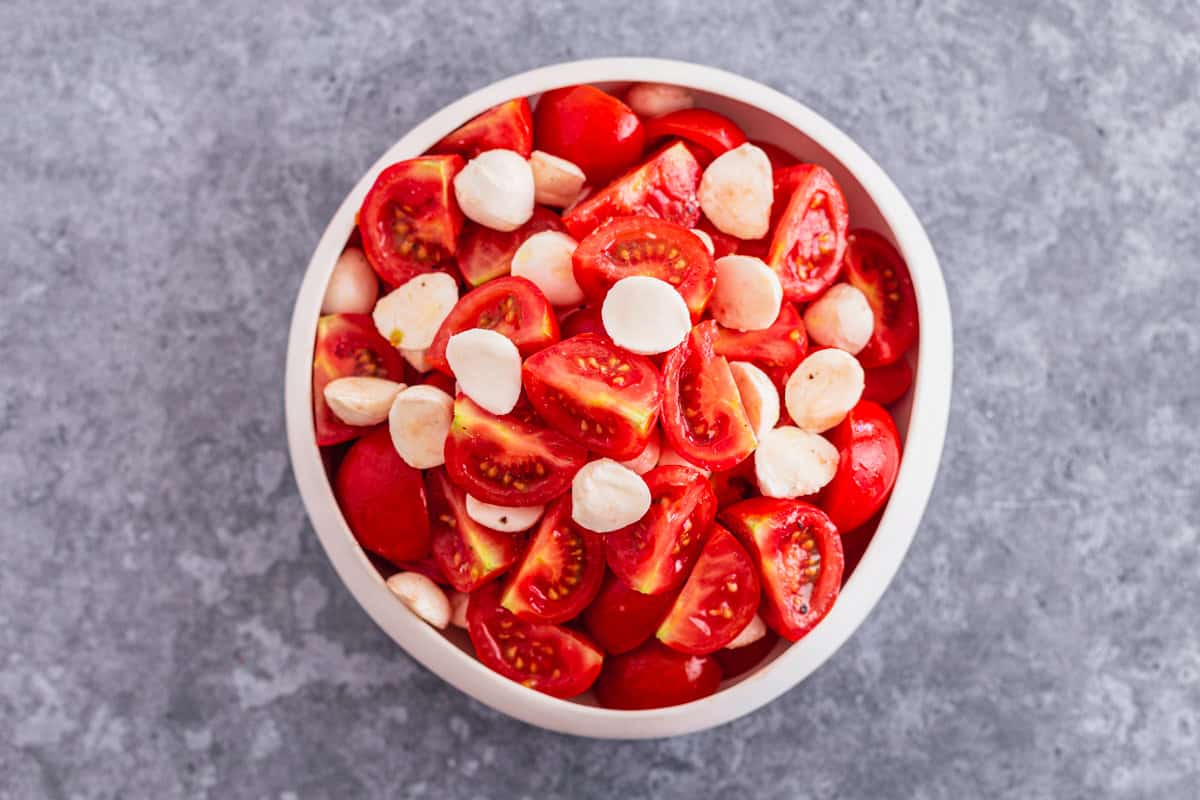 tomatoes and mozzarella balls mixed in a bowl
