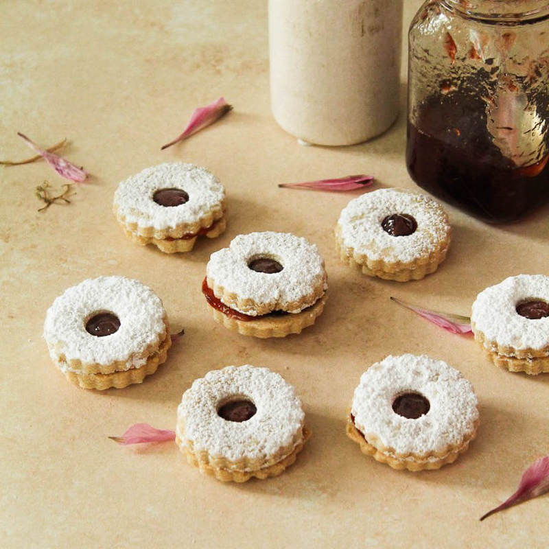 Linzer cookies with jam on a table